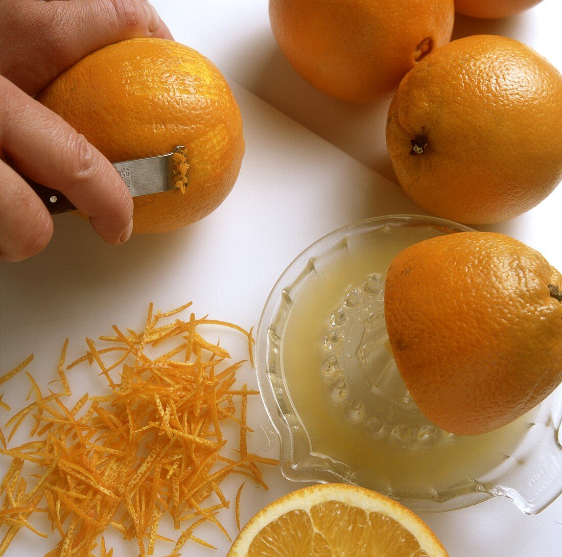Squeezing and zesting orange halves