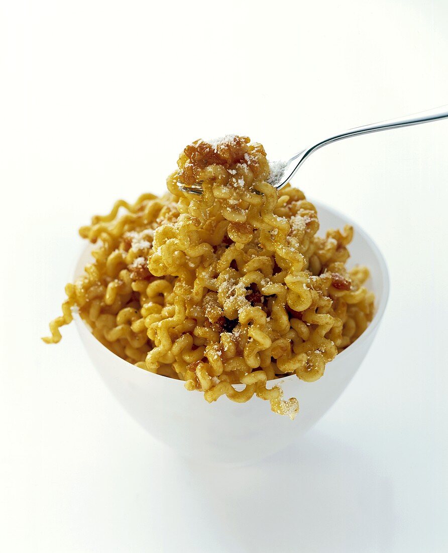 A bowl of fusilli with tomato sauce and parmesan