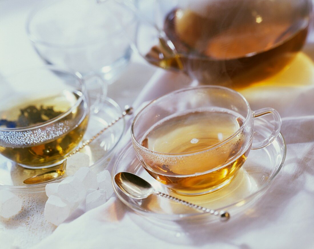 Two cups of tea and glass teapot