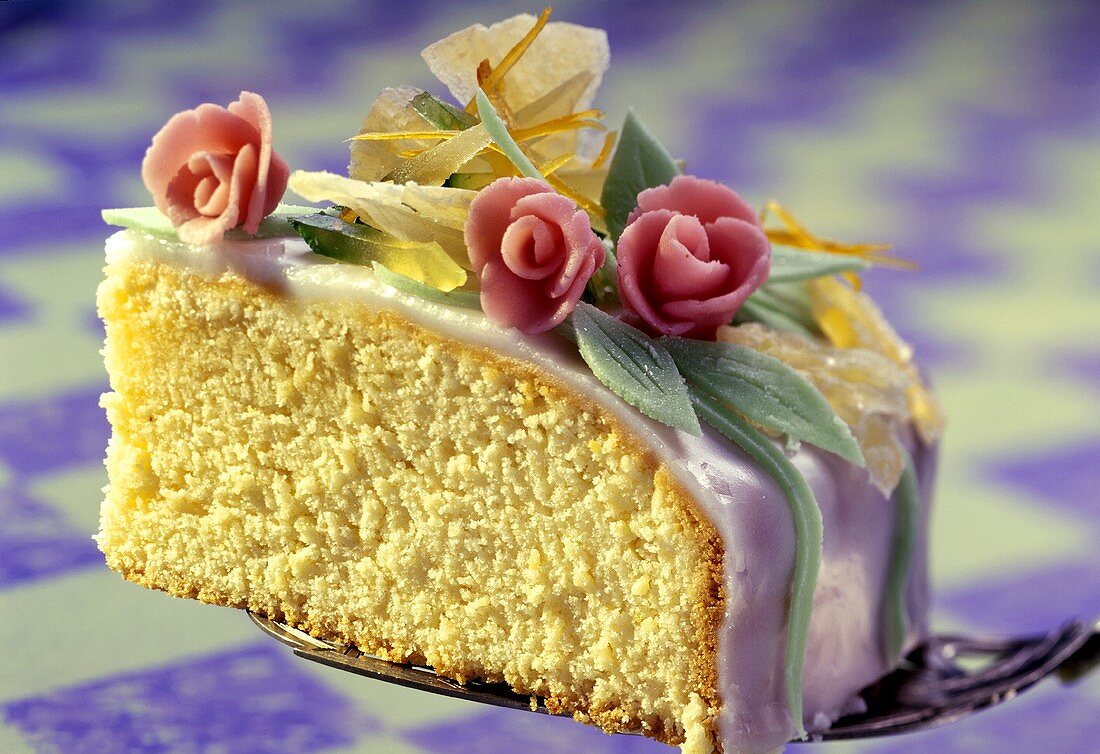 A piece of sponge cake with icing & marzipan roses