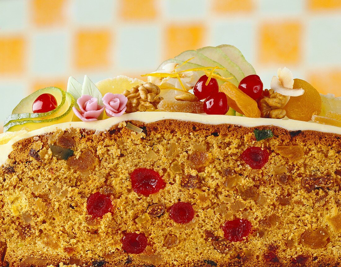 A rich sponge cake with candied fruit, cut in half