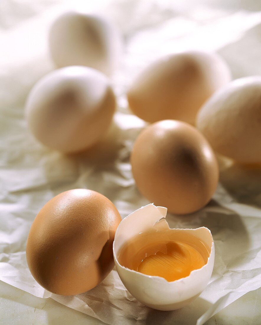 Several hens' eggs, one broken open