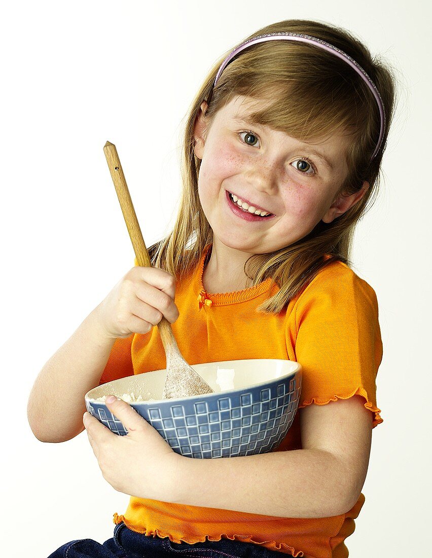 Girl stirring mousse in a dish