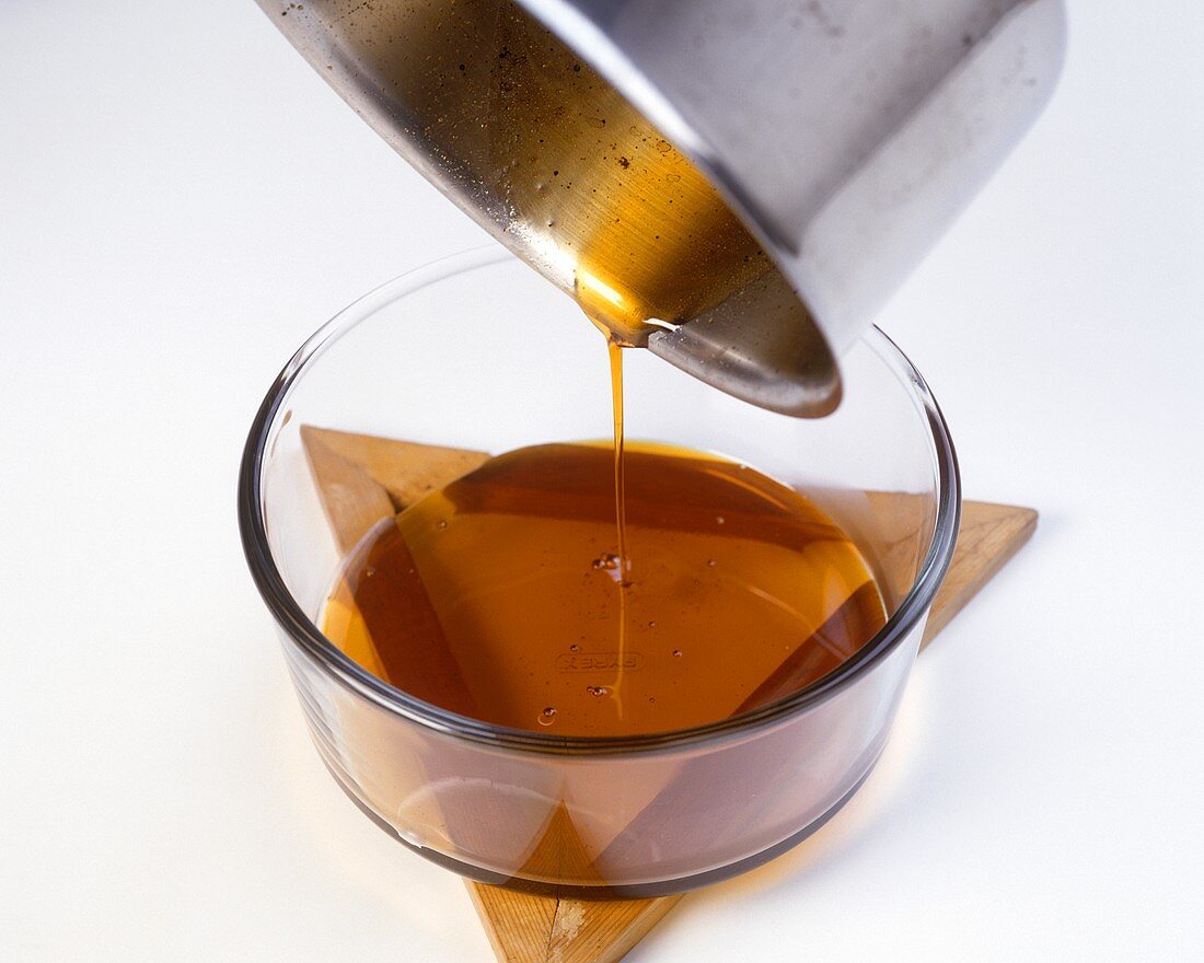 Pouring liquid caramel into a glass mould