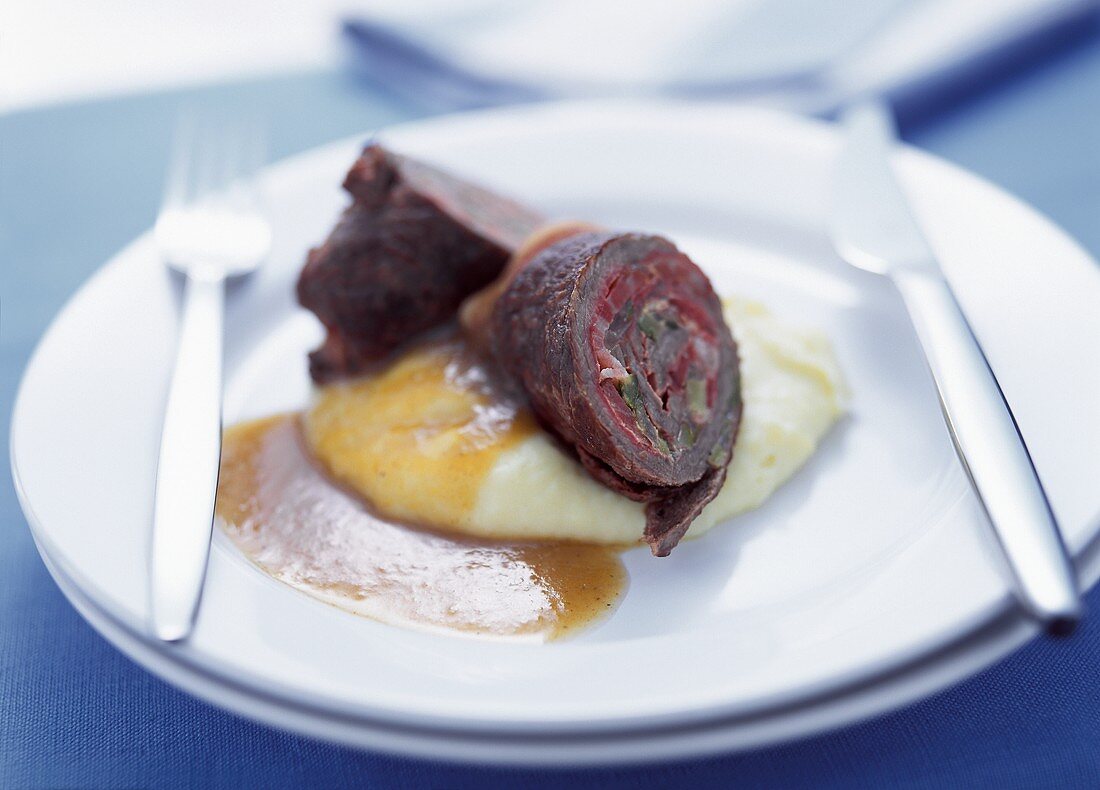 Beef roulades with bacon & cucumber stuffing on mashed potato