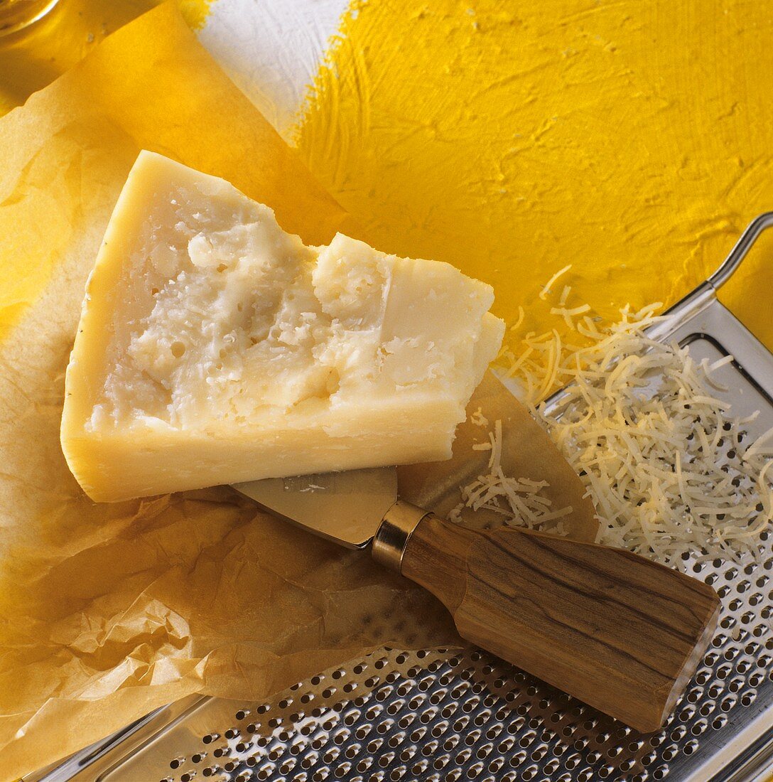 Parmesan cheese with grater and knife