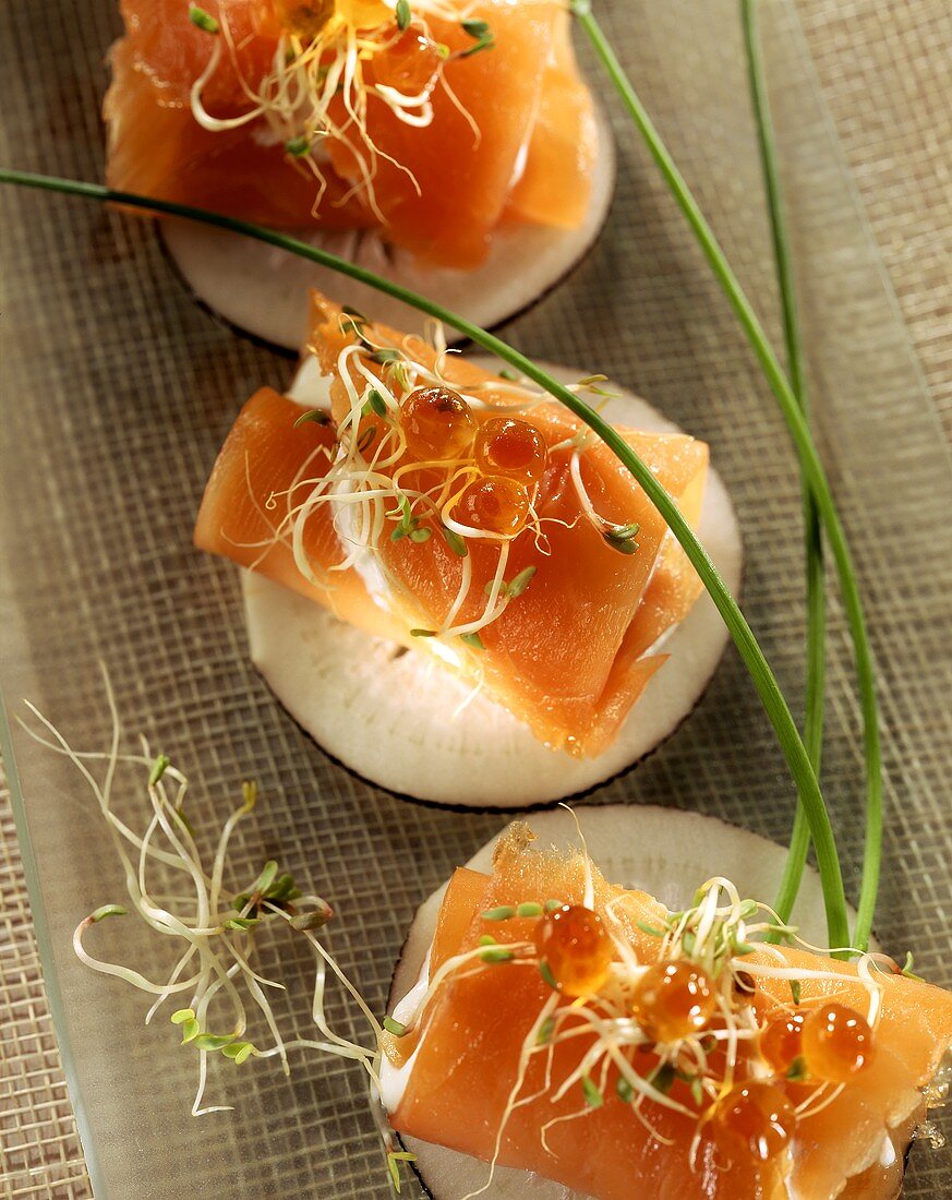 Salmon roll with goat's cheese on radish slice