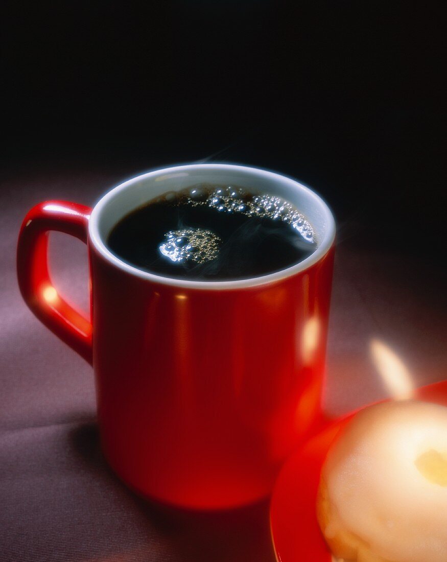 Tasse Kaffee mit Doughnut