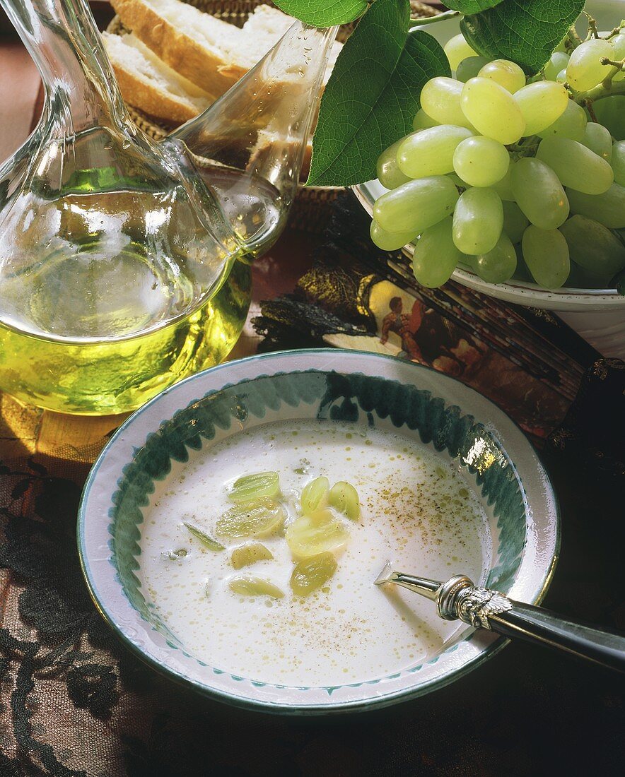 Cold grape and almond soup with grapes and oil carafe