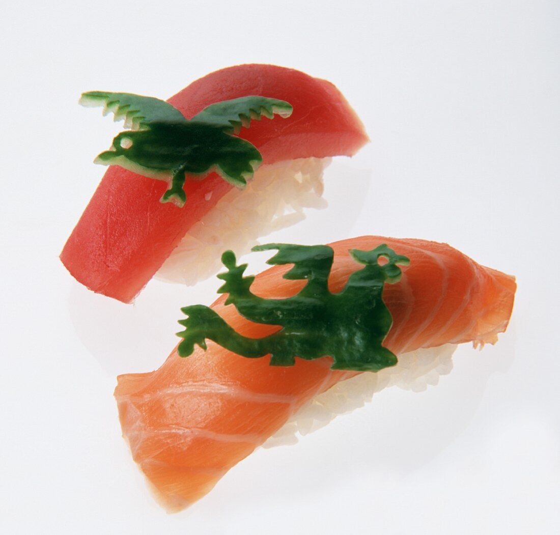 Two nigiri sushi with green pepper animal figures