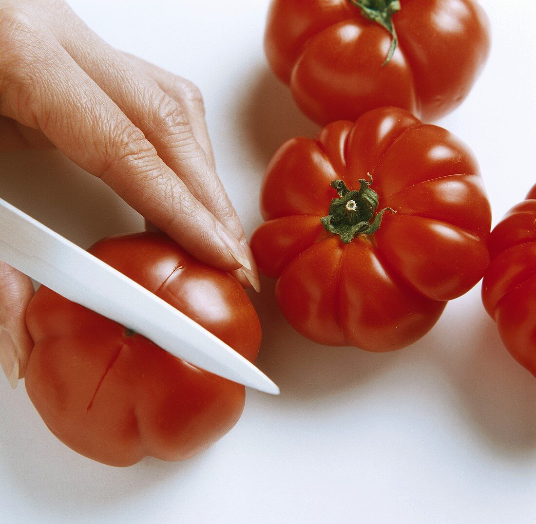 Cutting a cross into a beefsteak tomato