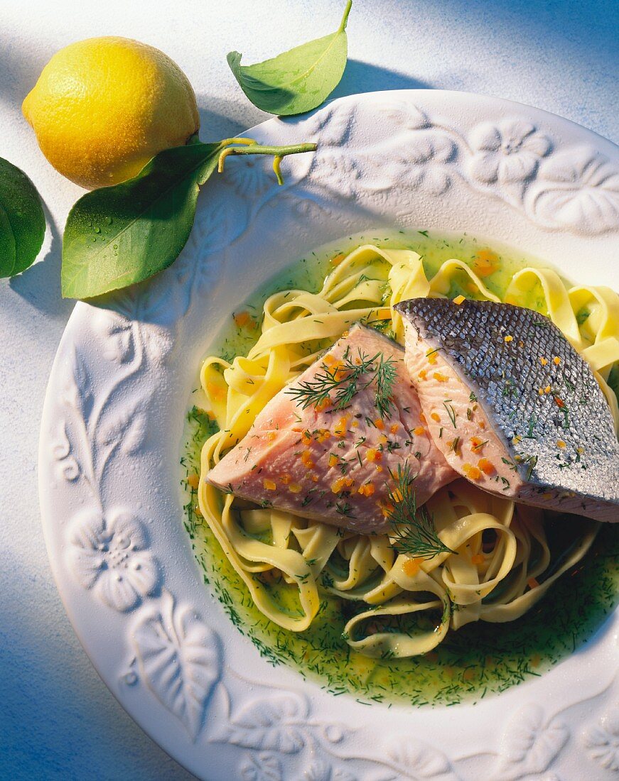 Steamed salmon fillet on ribbon pasta and lemon and dill sauce