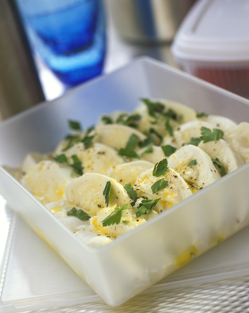 Marinated mozzarella with parsley in a sandwich box