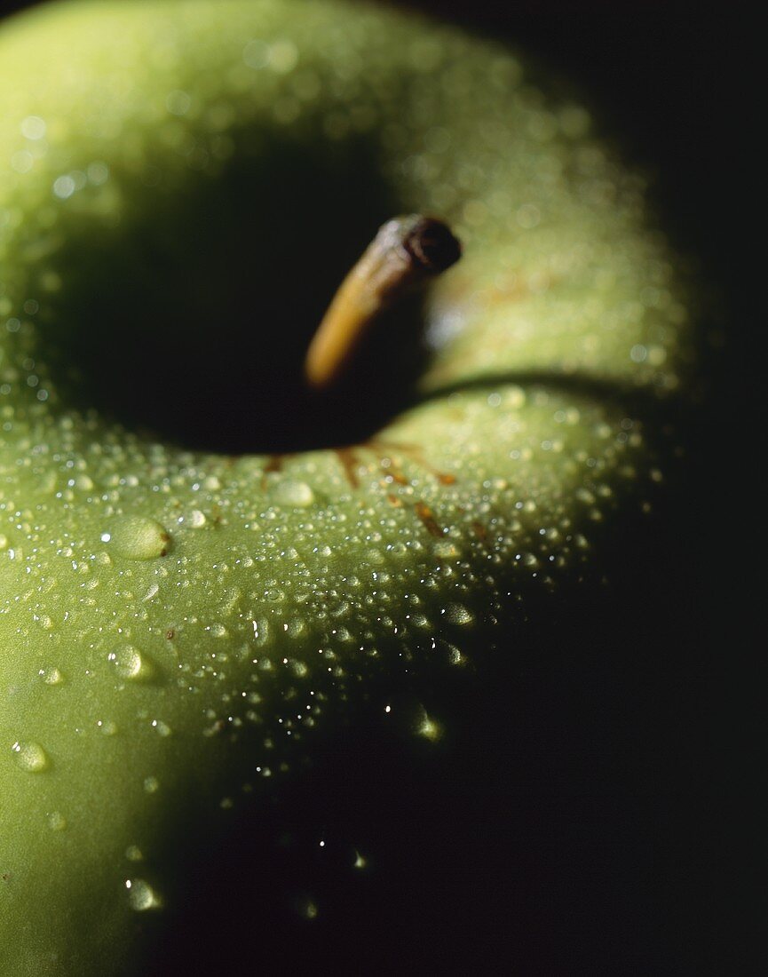 Granny Smith apple with drops of water