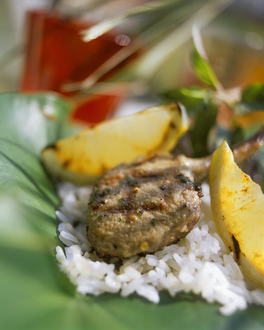 Grilled lamb cutlet with lemon wedges and rice