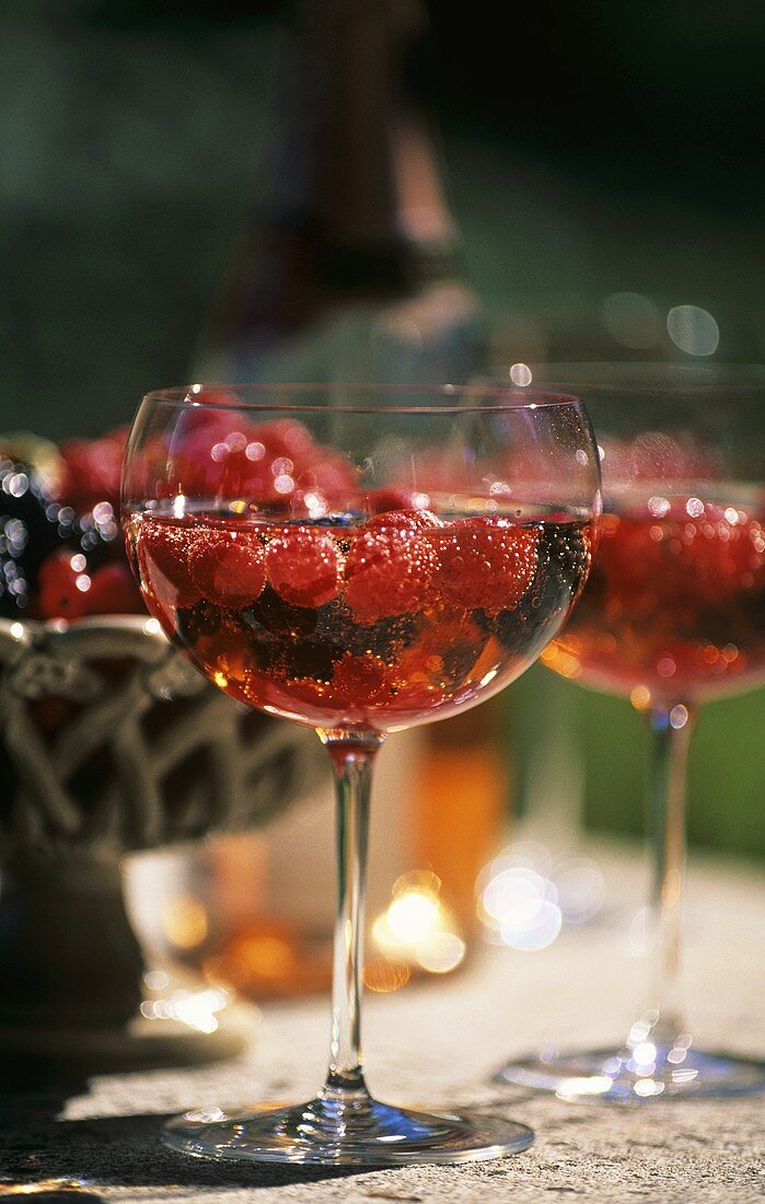 Champagne with berries in glass