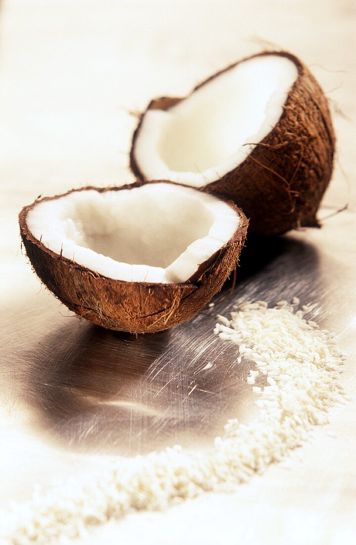 A halved coconut with grated coconut