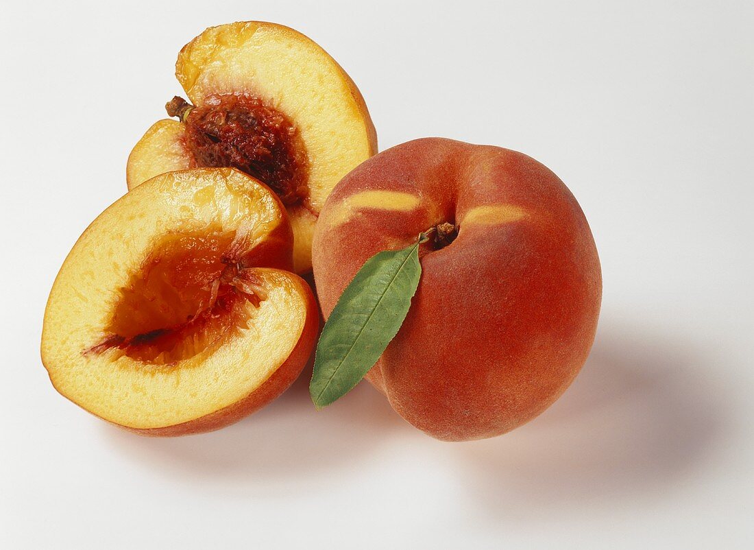 Two peaches, one halved