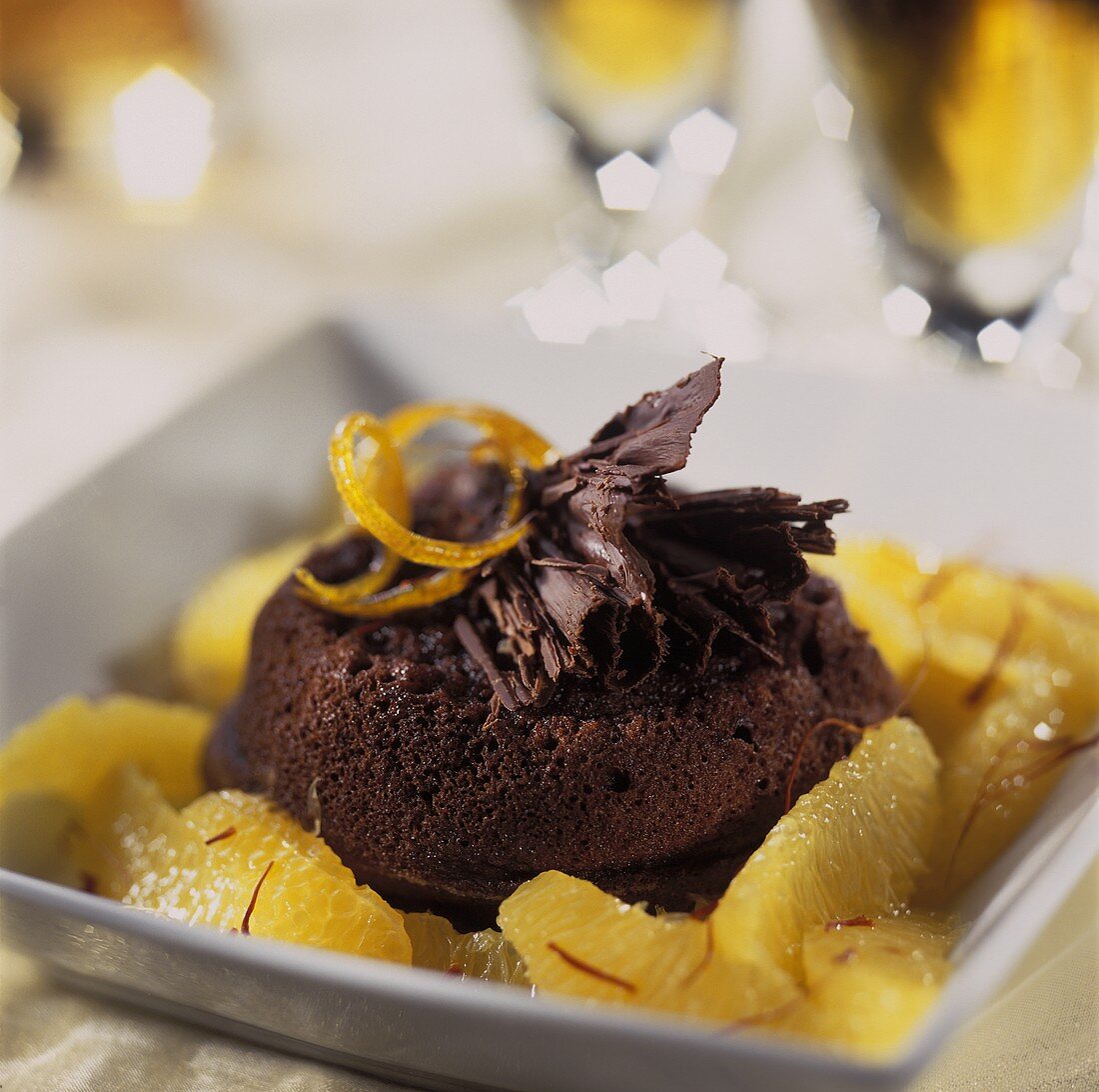 A small chocolate cake with orange segments