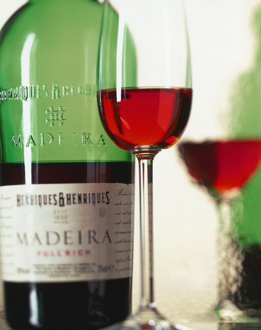 A glass of Madeira, bottle in background