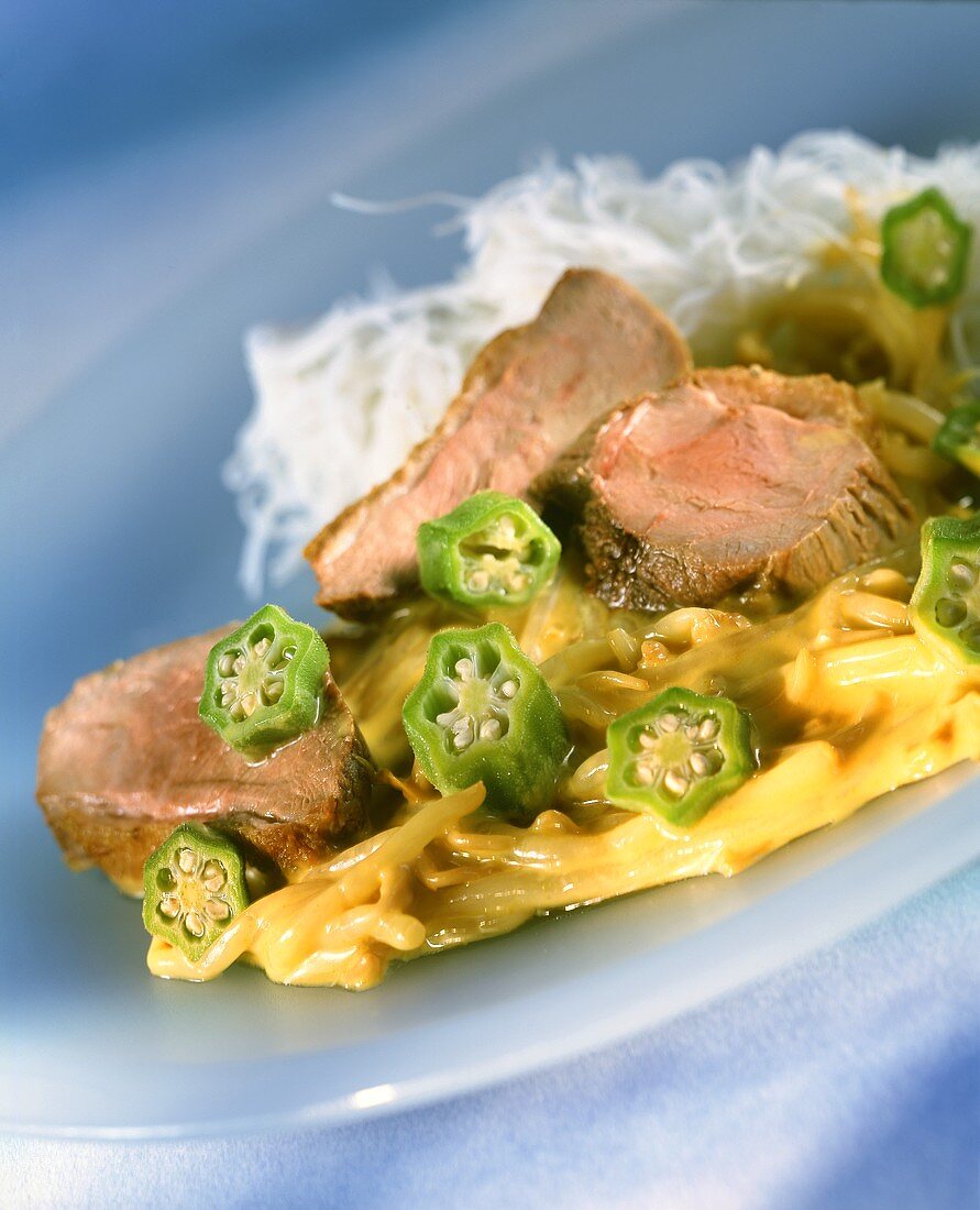 Duck breast and sprout curry with okra pods and rice noodles