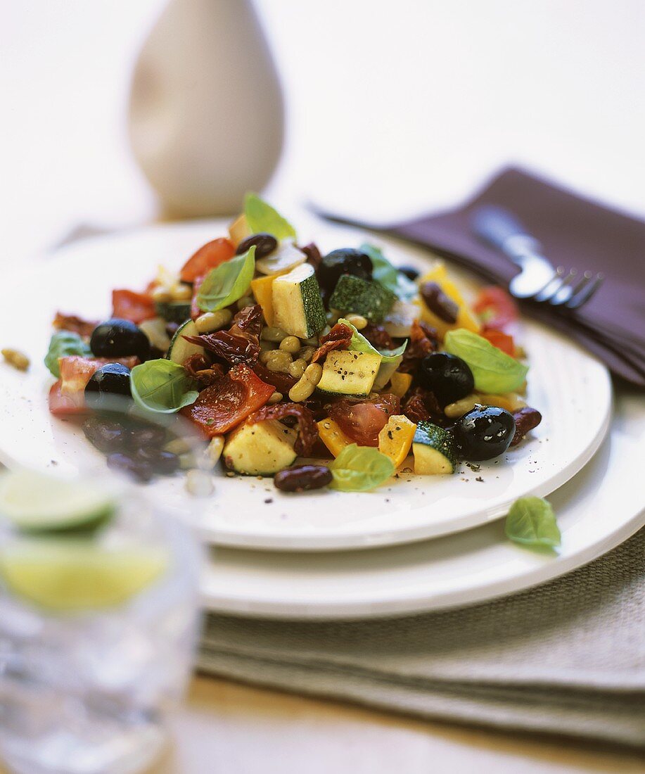 Warm vegetable salad with courgettes, beans & black olives