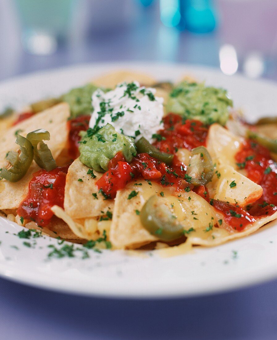 Baked nachos with various sauces