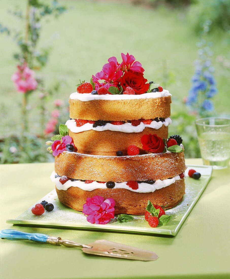 Multi-tiered berry gateau decorated with flowers