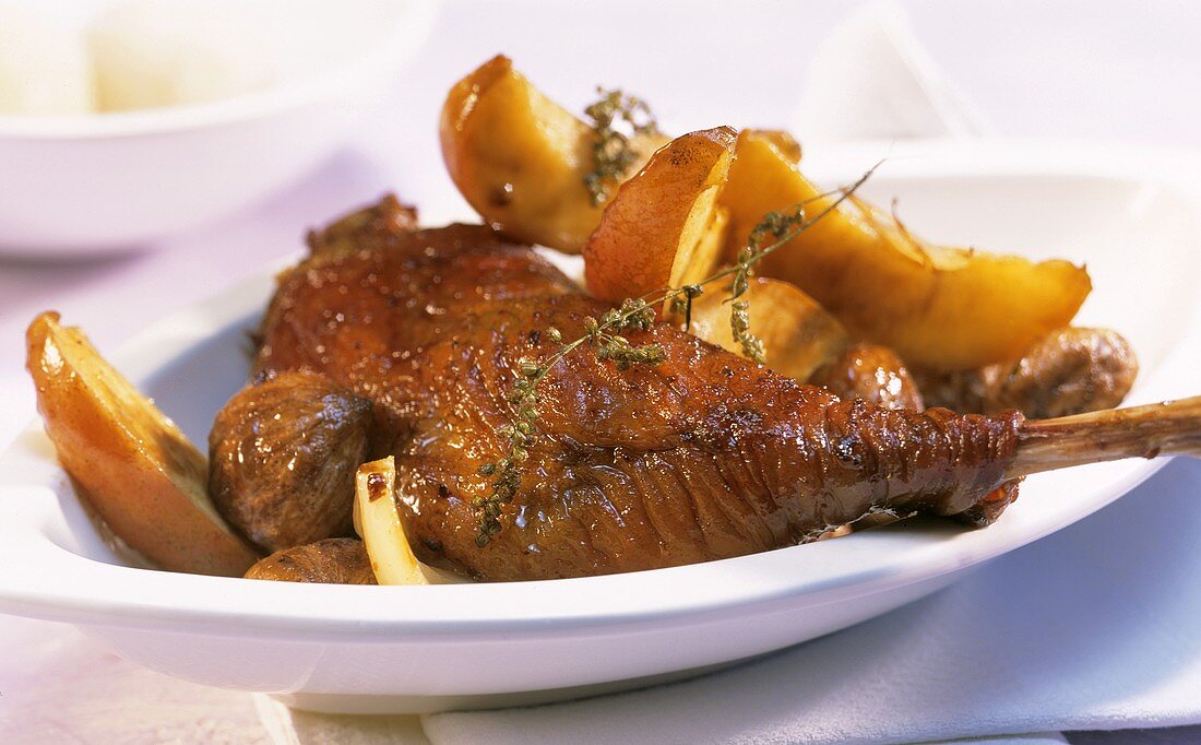 Goose leg with apple slices, chestnuts and mugwort