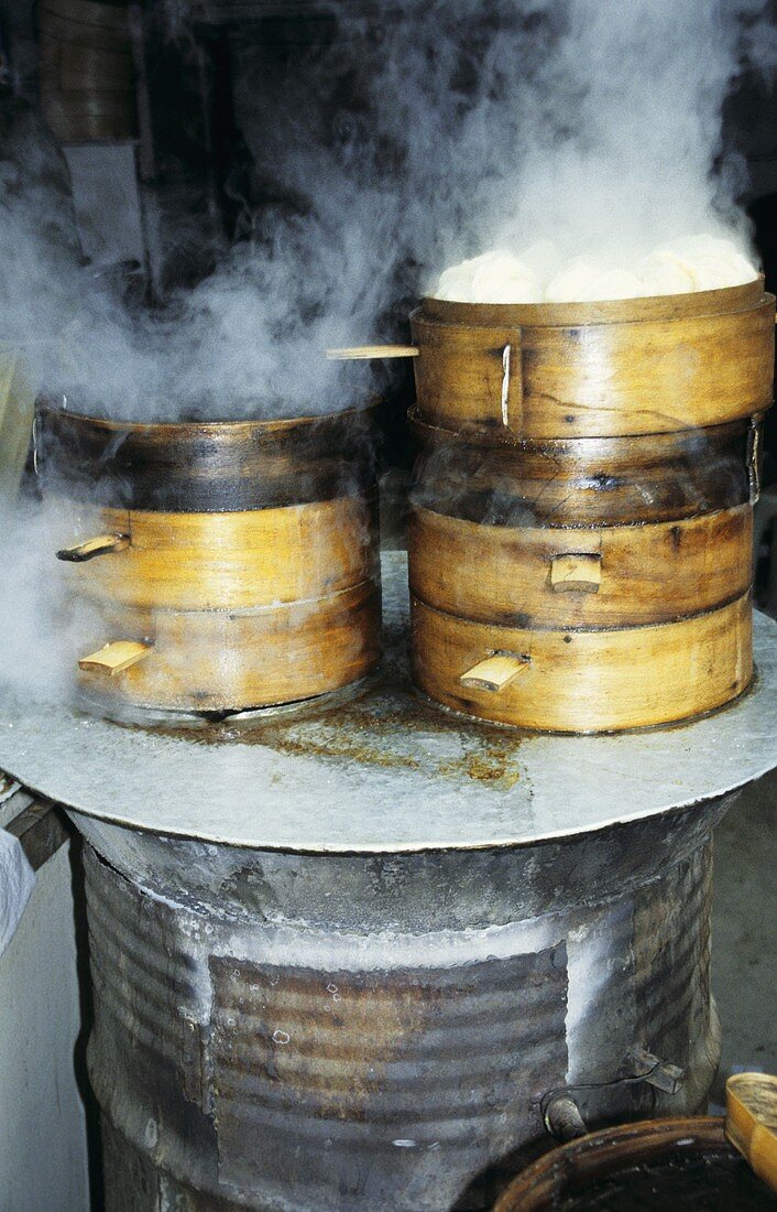 Steaming Chinese steamed noodles in basket at market