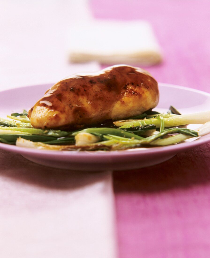 Chicken breast with soya vanilla sauce on spring onions