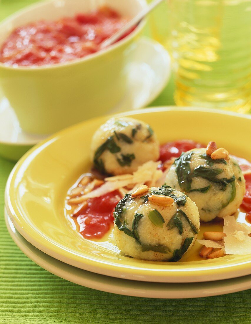 Spinach dumplings with tomato sauce