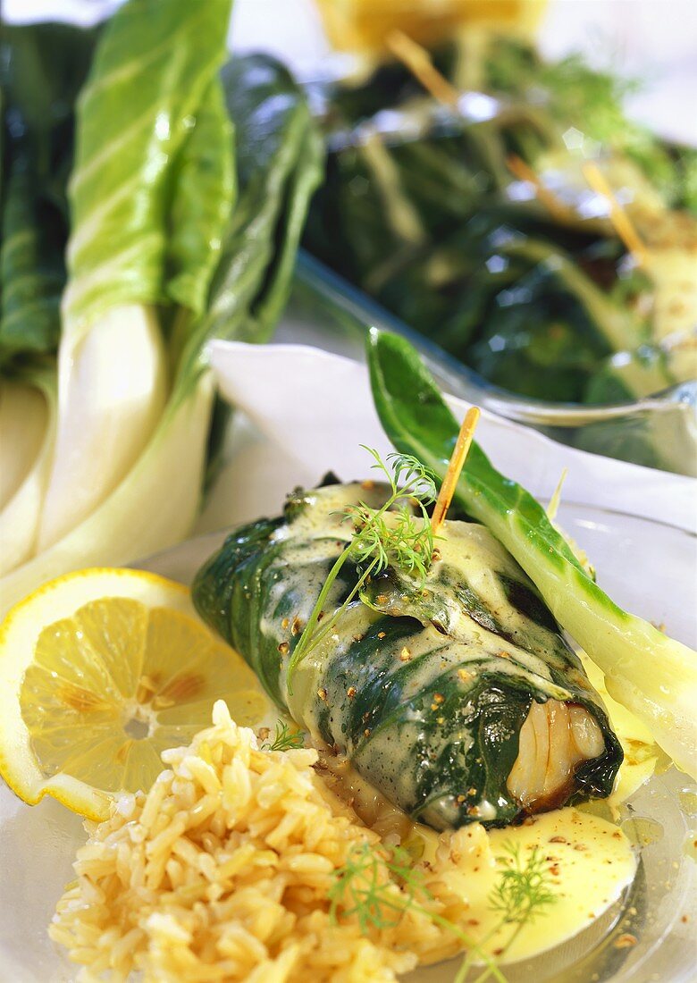 Chard and fish rolls with white sauce and rice