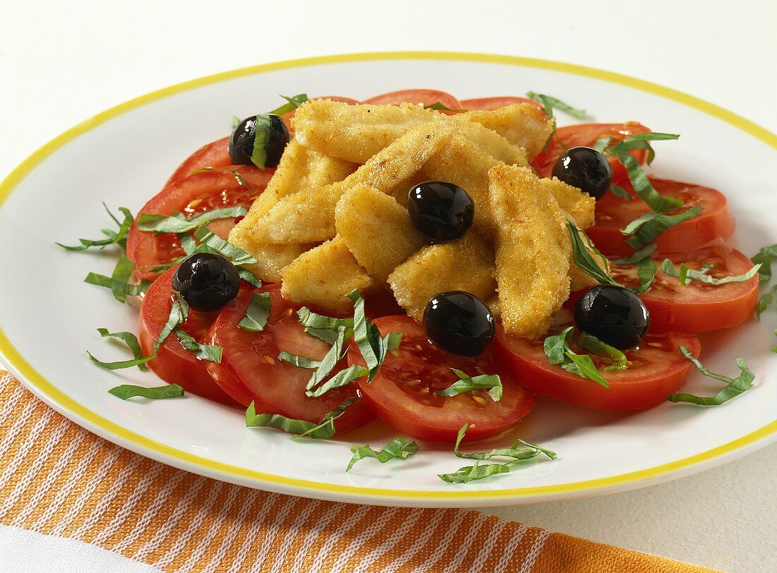 Baked mozzarella sticks with olives and tomatoes