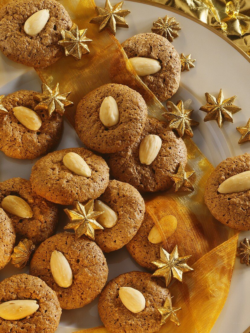 Chocolate almond macaroons with stars on gold-rimmed plate