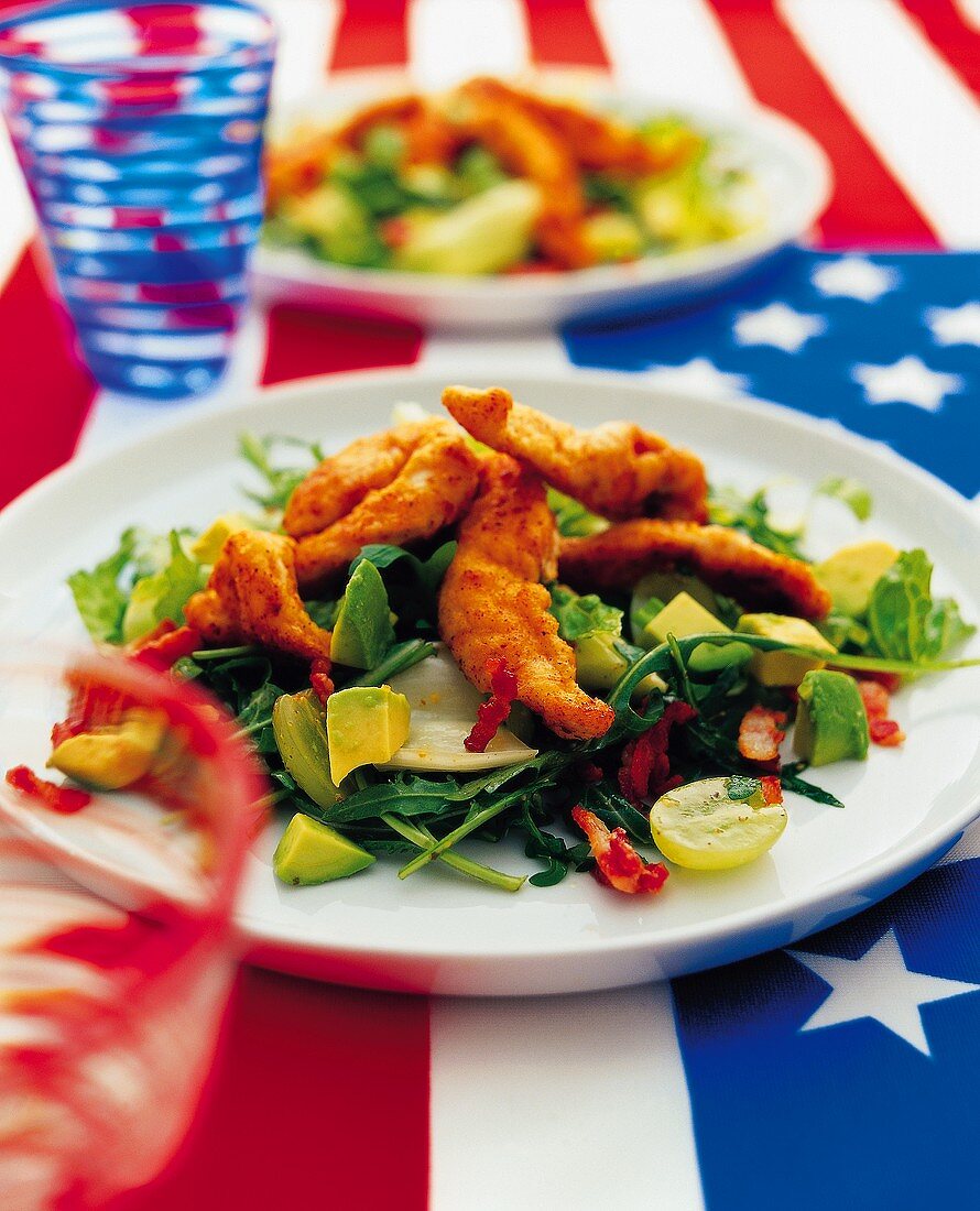 Mixed salad with avocado and fish strips