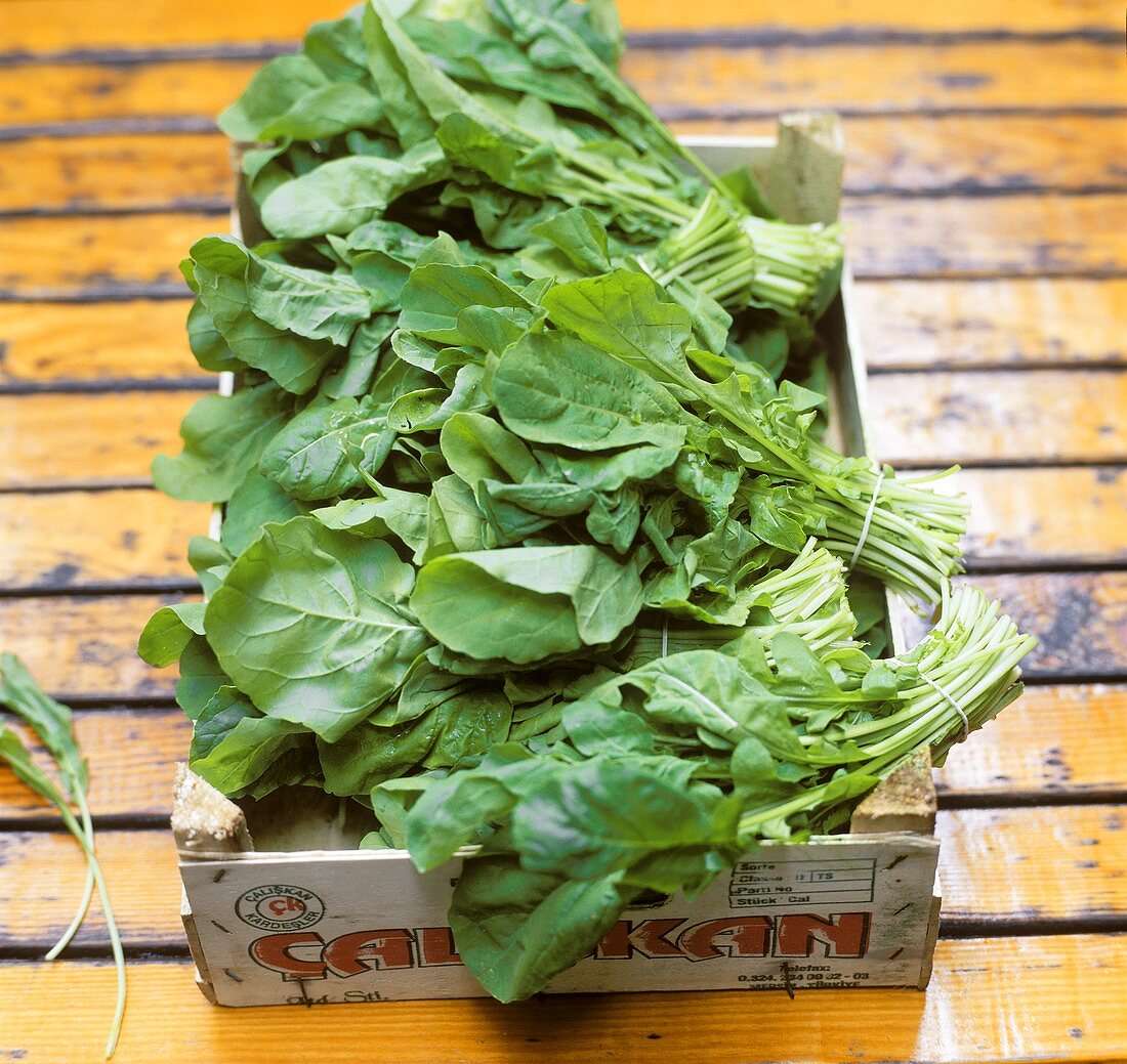 Several bundles of rocket in wooden crate