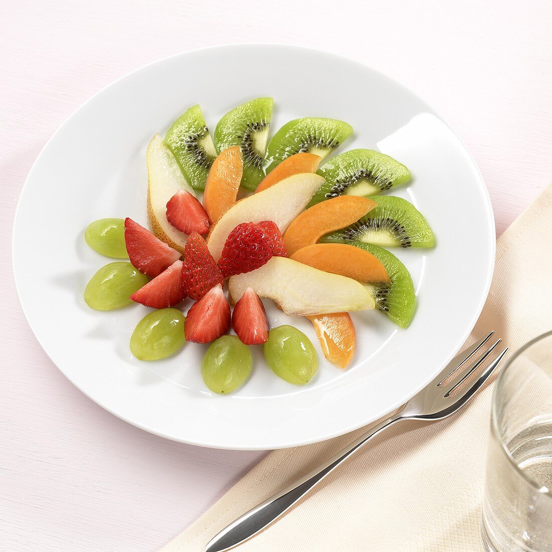 Fruit plate with grapes, strawberries, kiwi slices etc