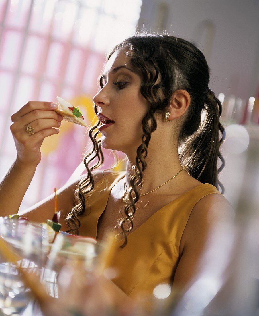 Young woman eating appetiser