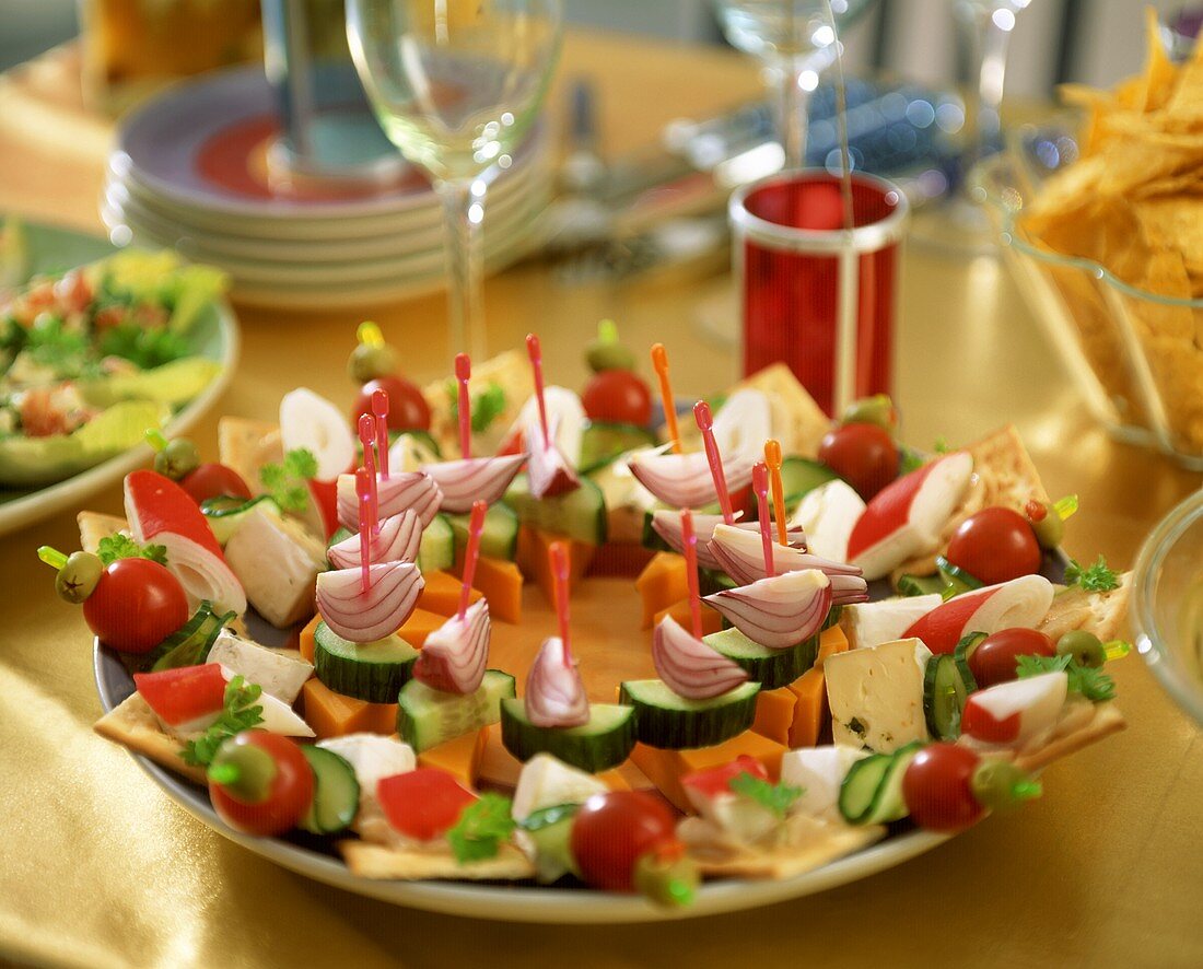 Cocktail sticks with vegetables, cheese and crackers