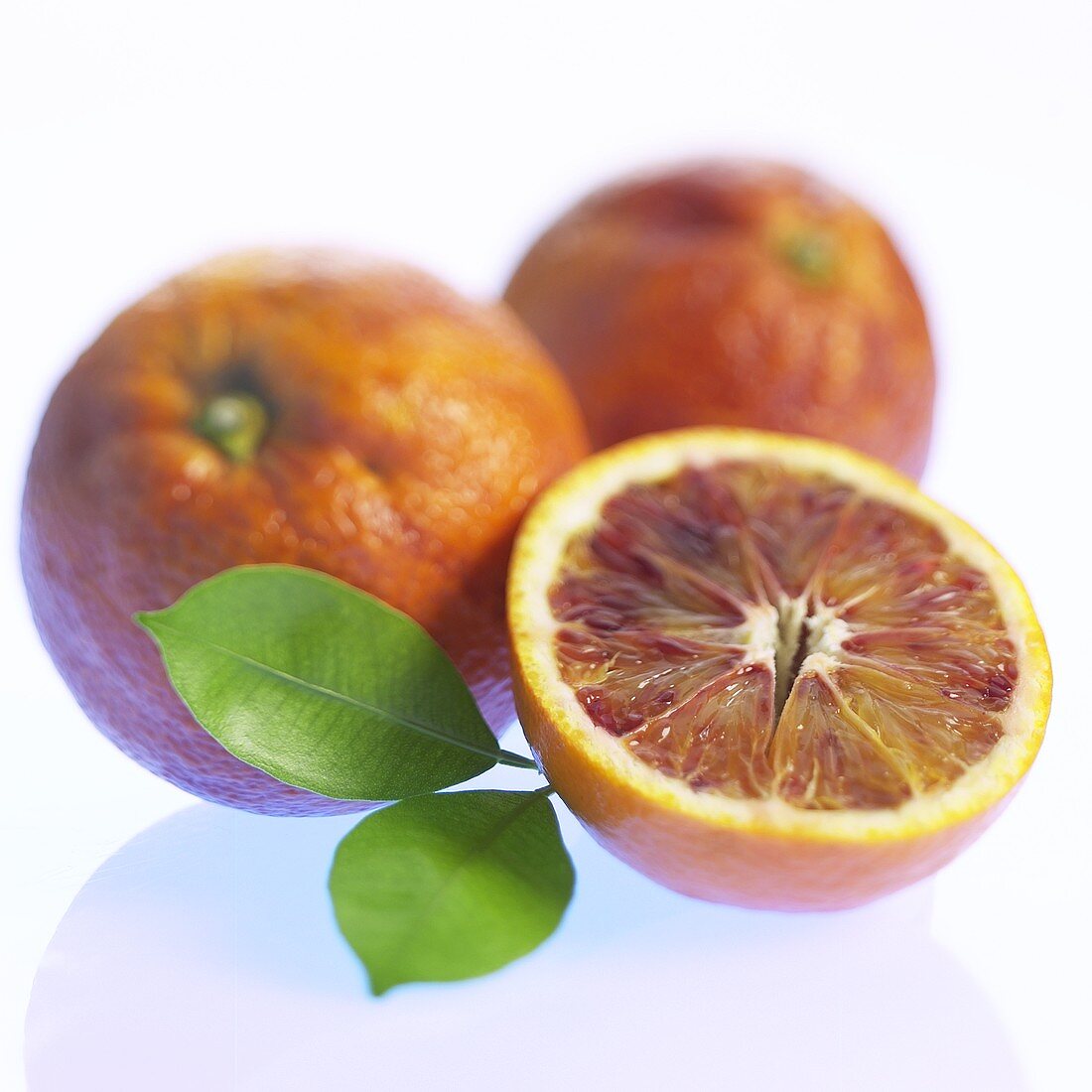 Blood oranges, whole and halved