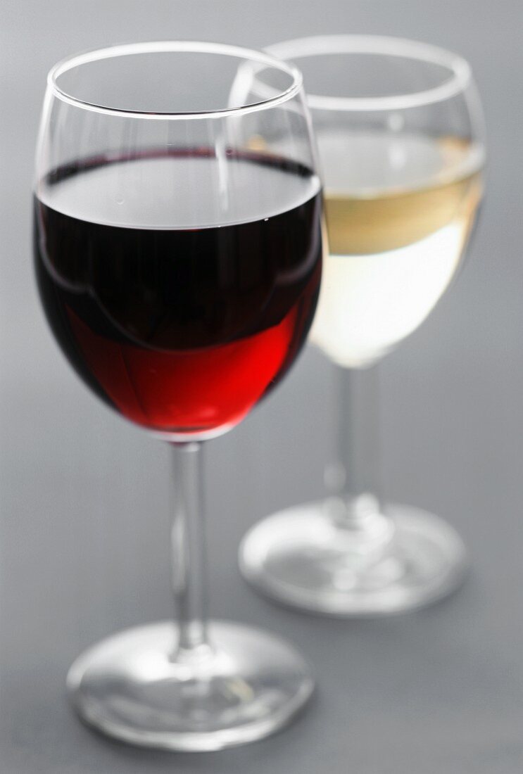 A glass of red wine and a glass of white wine