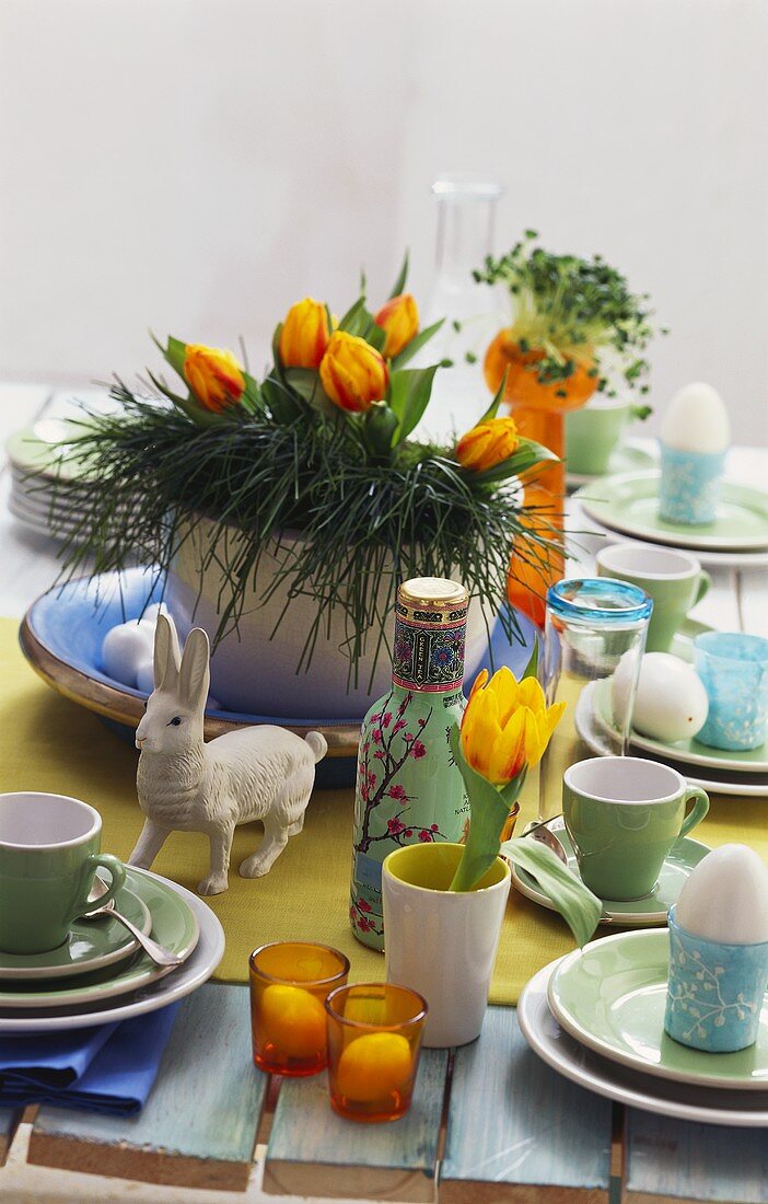 Table laid for Easter with cups and eggs 