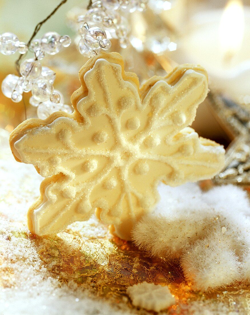 A star-shaped vanilla biscuit with orange and lemon icing