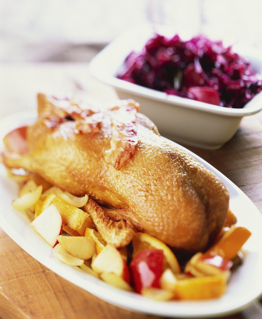 Roast goose with bacon and fruit, with red cabbage
