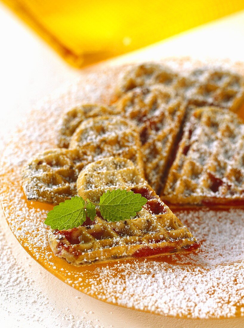 Cherry waffles, garnished with icing sugar & mint leaves