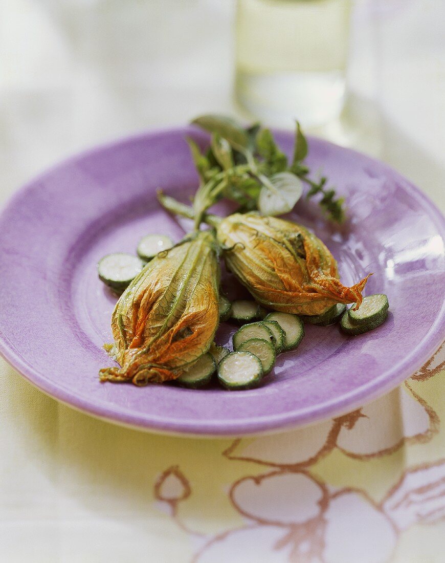 Stuffed courgette flowers on steamed courgette slices
