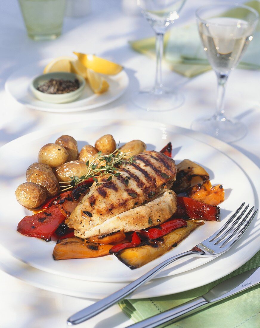Grilled chicken steaks with marinated pepper & potatoes