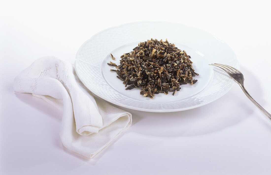 Boiled wild rice on white plate
