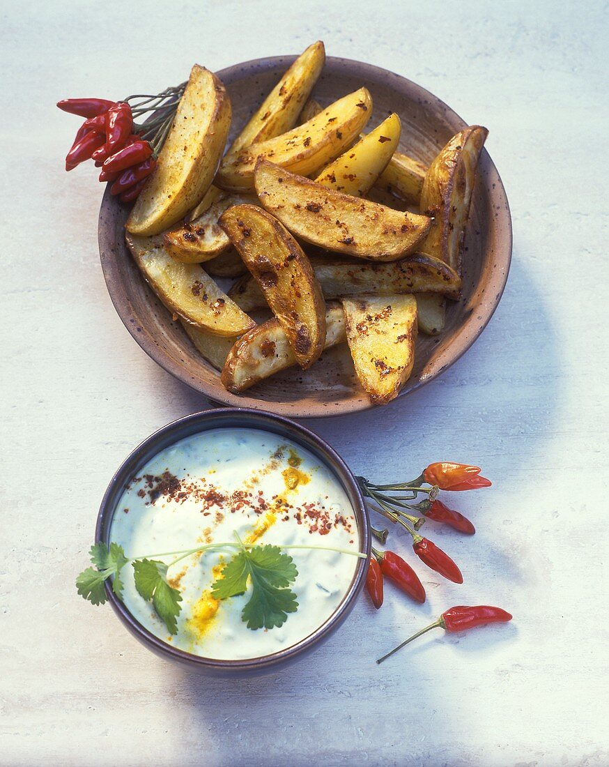 Baked potato wedges with spicy yoghurt dip